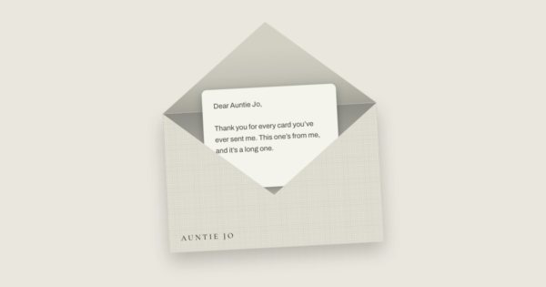 A linen envelope, open, with a letter to Auntie Jo beginning “Thank you for every card you’ve ever sent me”