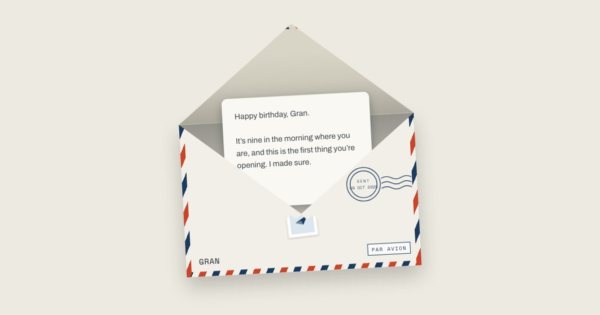 A red, white and blue airmail envelope marked Par Avion, open, with a letter beginning “Happy birthday, Gran”