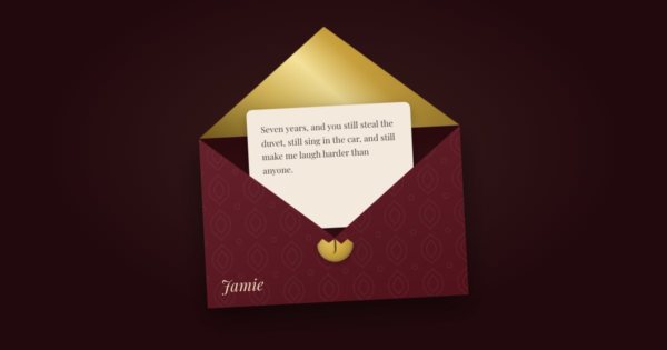 A deep red envelope with a gold lining, open, with a letter to Jamie beginning “Seven years, and you still steal the duvet”