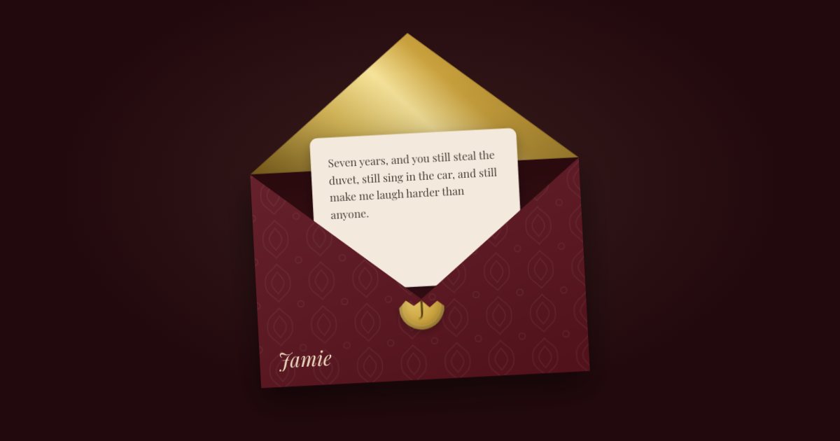 A deep red envelope with a gold lining, open, with a letter to Jamie beginning “Seven years, and you still steal the duvet”